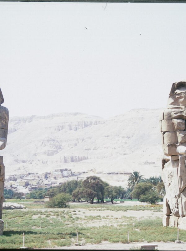 View of the Colossi of Memnon statues in Luxor, Egypt highlighting ancient Egyptian architecture.