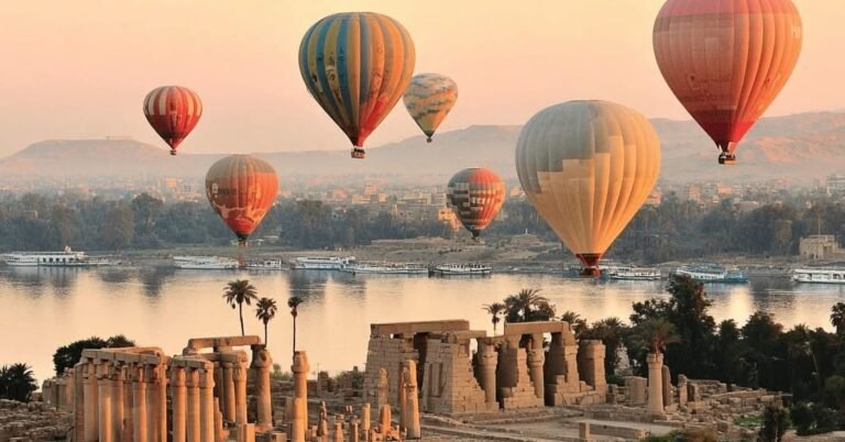 Hot air balloons over the Nile and the temples of Luxor at sunrise