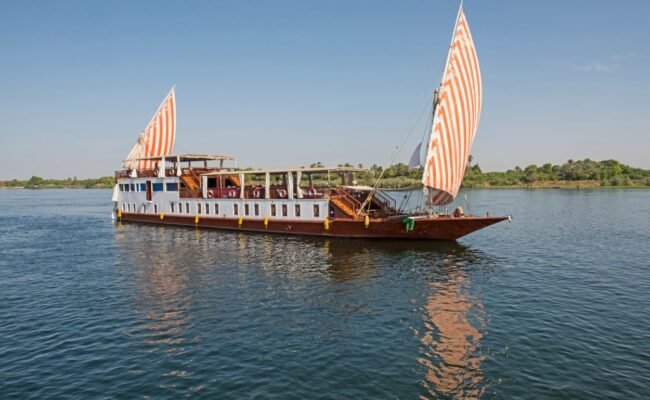 Private Dahabiya Nile cruise sailing between Aswan and Luxor Deck of a 5-star Dahabiya Nile cruise at sunset Kom Ombo Temple seen from a Dahabiya Nile cruise