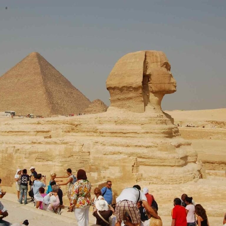 The Great Sphinx and a pyramid at Giza with visitors